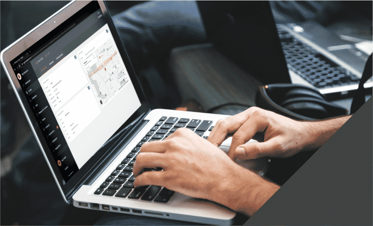 Builder working with Buildxact on his laptop