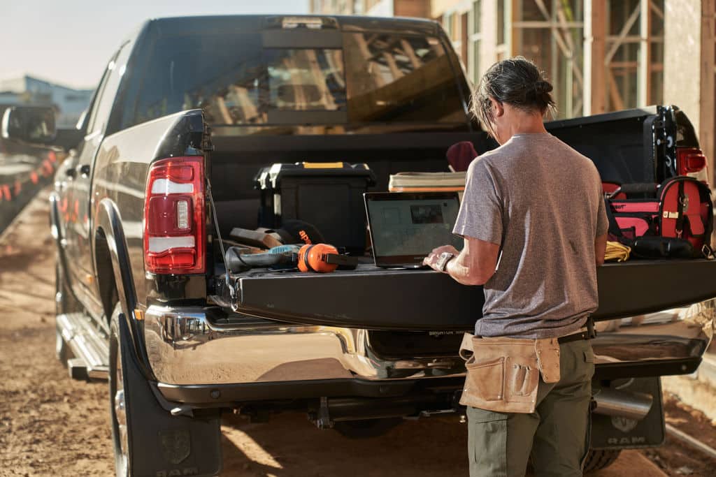A builder checks an estimate from the job site using his laptop.