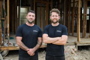 VW Builders founders pose in front of a home build.
