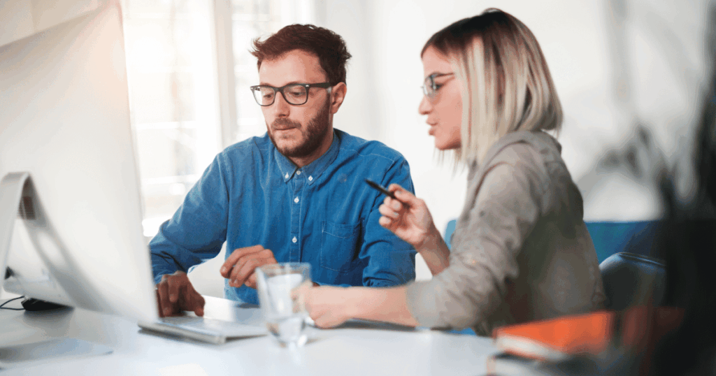 Customers sit a table in their home reviewing a builders web site.