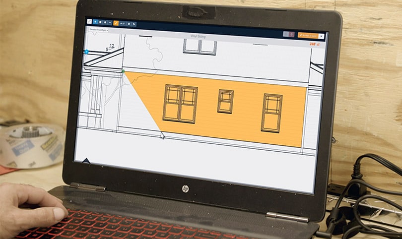 BIM management example showing a residential building model on a laptop used for construction planning and quantity takeoffs.