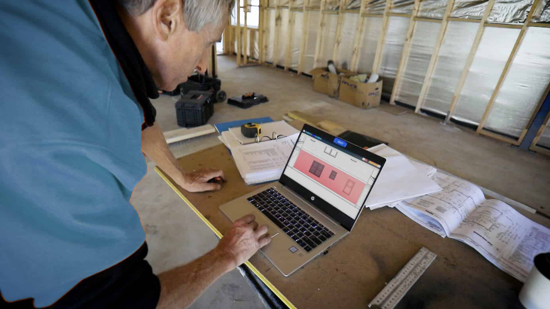 Man working on plans during a residential build.